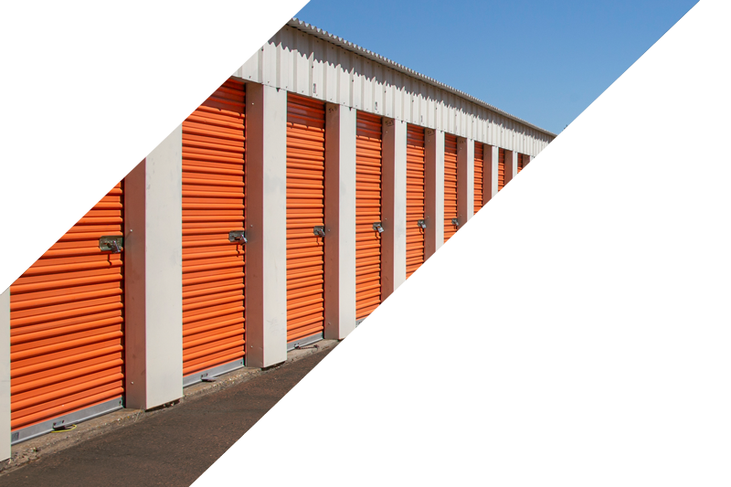 Two service representatives with a clipboard in front of the orange storage containers 